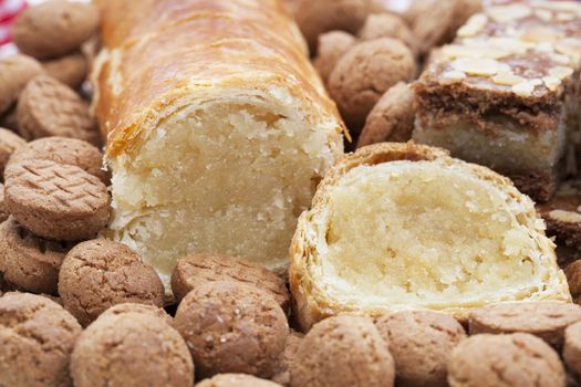 Dutch Christmas season treats, an almond roll surrounded by kruidnootjes and speculass