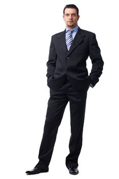  Portrait of a confident young  businessman with hands in pockets on white background.