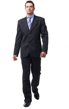 Full length portrait of a confident businessman walking isolated on white.