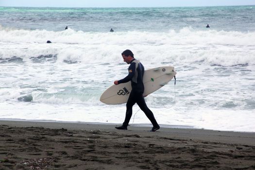 Surfer on the beach in Levanto, Italy