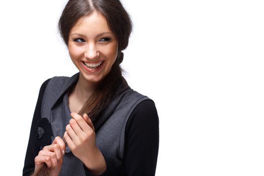 Portrait of a happy young girl playing with her hair over white.