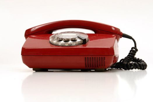 a red retro phone on white............