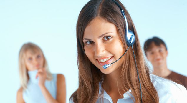 Young beautiful woman with headset with some people at the background
