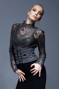 Portrait of a beautiful model in black, lace blouse, posing.