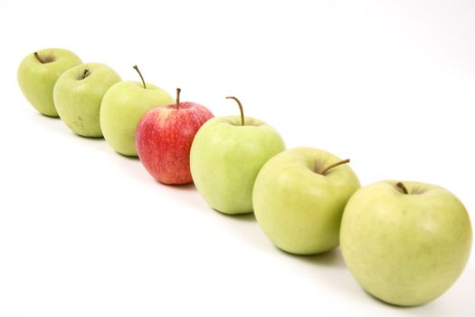 apples arranged on a white background to symbolize teamwork, leadership, discrimination............