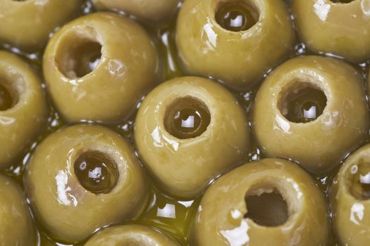 Texture of pitted olives covered in olive oil and ready to eat