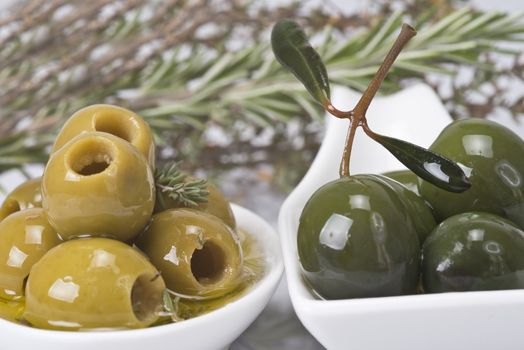 Pitted olives in a saucer isolated on a white background.