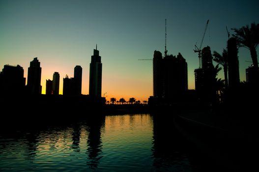 beautiful view of dubai city at night with reflections in water