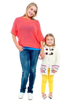 Mum and daughter posing in trendy outfits. Full length portrait
