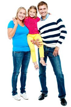 Full length portrait of a cheerful family of three dressed in trendy casuals
