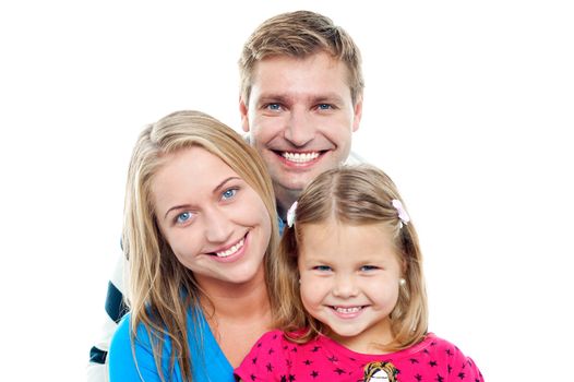 Smiling young love couple posing with cute daughter isolated on white. Adorable family