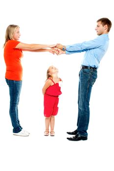 Playful parents holding hands while cute daughter keenly watches them