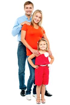 Full length portrait of adorable caucasian family of three standing behind one another