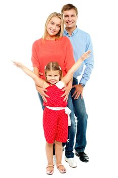 Cheerful family of three posing indoors. Isolated over white