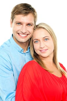 Profile shot of an adorable young love couple. Man hugging wife from behind