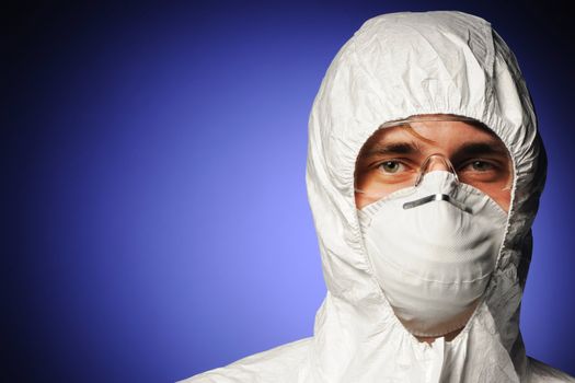 Scientist in protective wear, glasses and respirator 