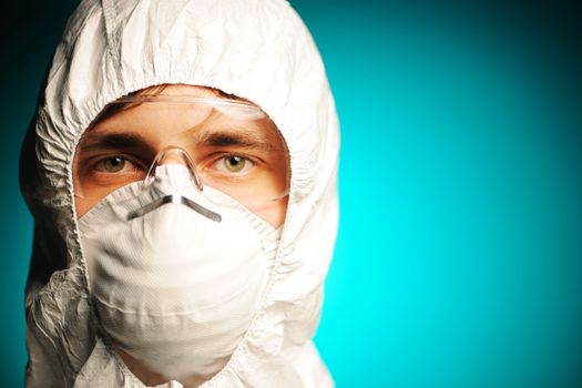 Scientist in protective wear, glasses and respirator 