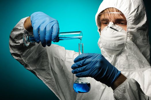 Scientist in protective wear, glasses and respirator 