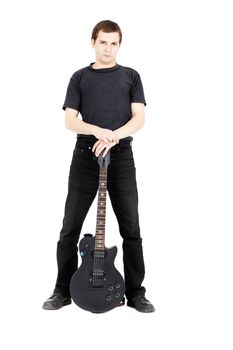 A young man with a black electric guitar isolated on white background