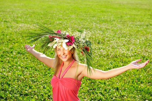 Girl wearing a wreath made from flowers with outstretched arms