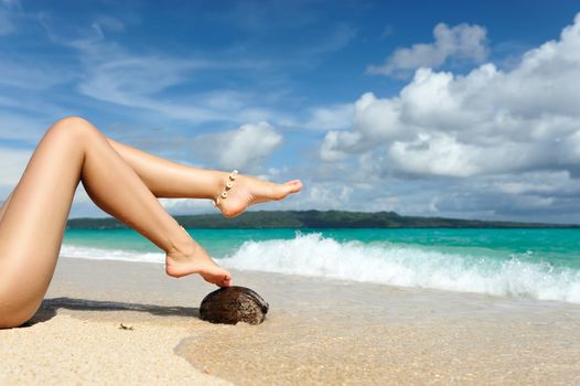 Women's beautiful legs on the beach