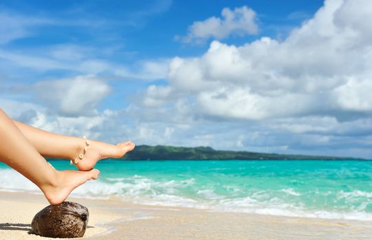 Women's beautiful legs on the beach