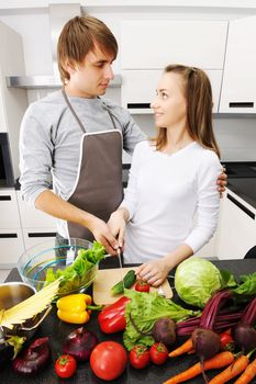 Couple cooking in modern kitchen