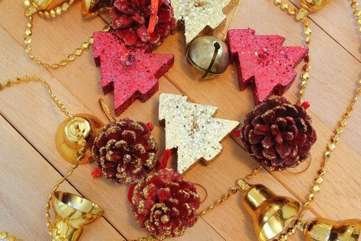 colorful christmas tree shaped candles and fir cones over wood