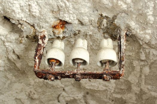 old electricity equipment in a salt mine ; the salt has drained off from the tunnel ceiling