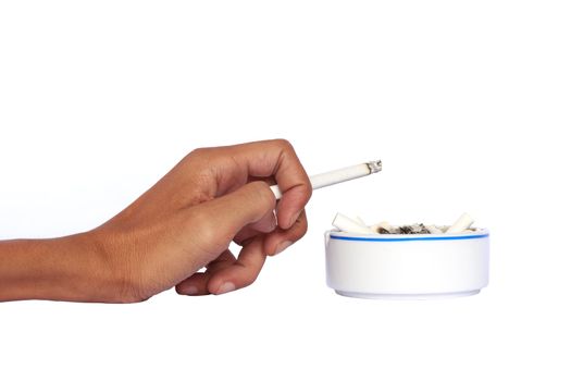 Isolated hand and ceramic ashtray with cigarettes.