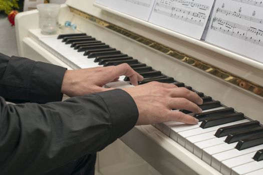 male hand on the piano
