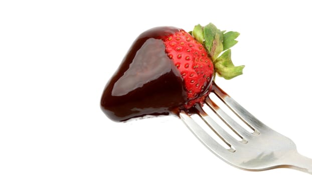 Strawberry with chocolate on the fork