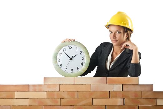 Female builder and clock on white