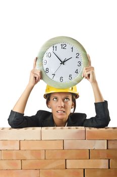 Female builder and clock on white