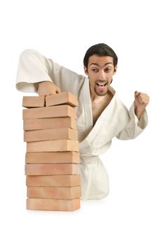 Karate man breaking bricks on white