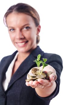 Businesswoman with seedling on white