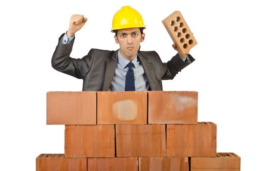 Businessman with bricks on white