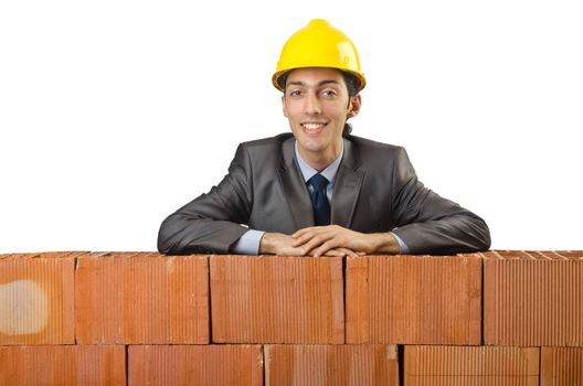 Businessman with bricks on white