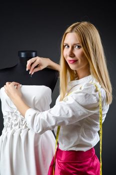 Woman tailor working on dress 