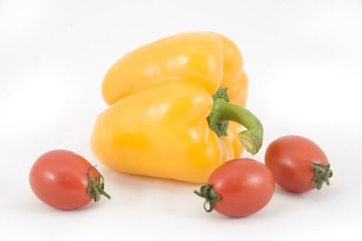 Sweet yellow peppers and tomatoes on white background