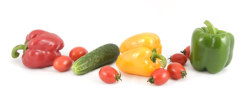 Sweet peppers, cucumbers and tomatoes on a white background