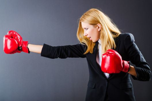 Woman boxer in dark room