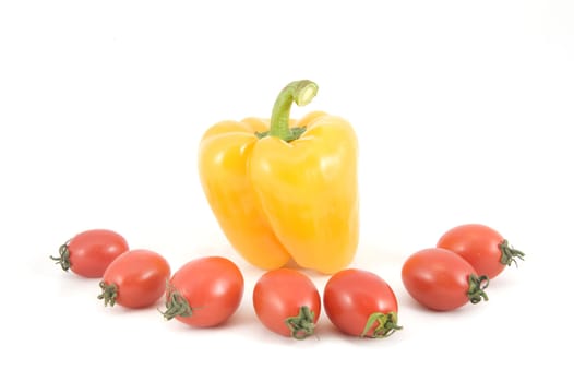 Sweet yellow peppers and tomatoes on white background