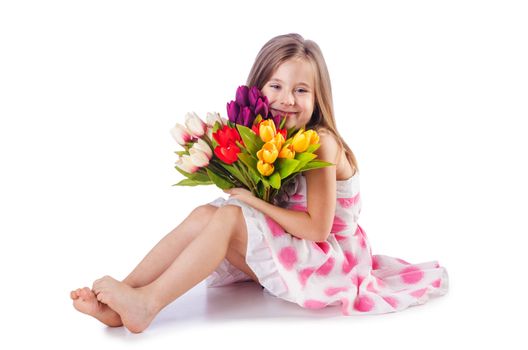 Cute little girl with flowers on white