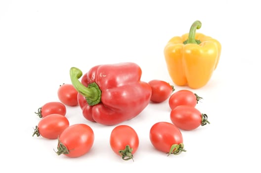 sweet peppers and tomatoes on white background