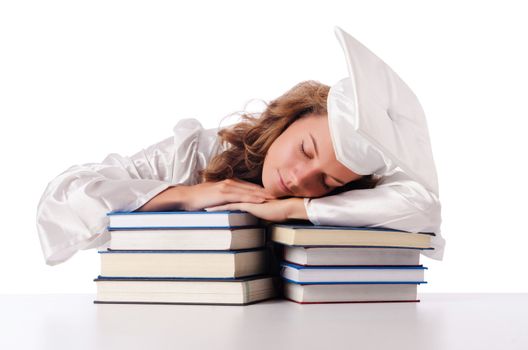 Happy graduate with lots of books on white