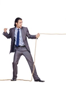 Businessman pulling rope on white
