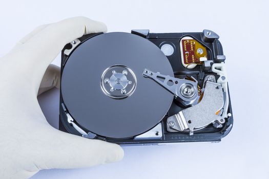 technician with open hard-disk in light background