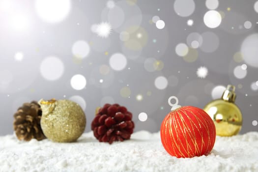 Christmas decoration ball on snow against lights background