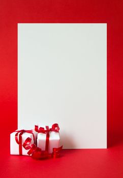 Two wrapped gifts represent christmas theme, with a blank white card for text